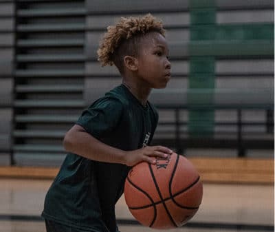 little guy shooting hoops